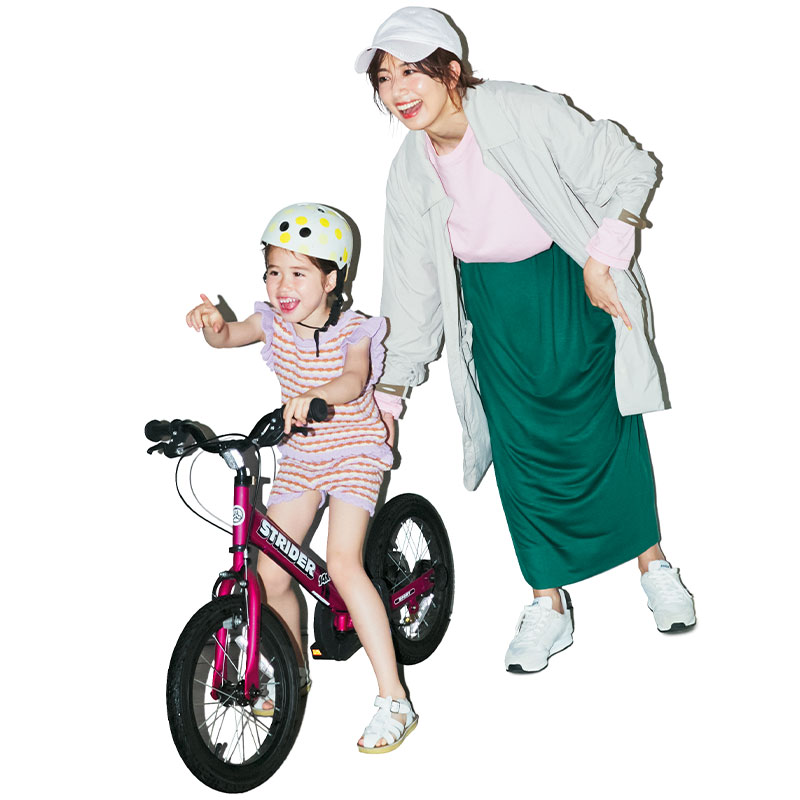 ピンクのTシャツにグリーンのスカート、ベージュのアウターを羽織った公園コーデの東原亜希さん