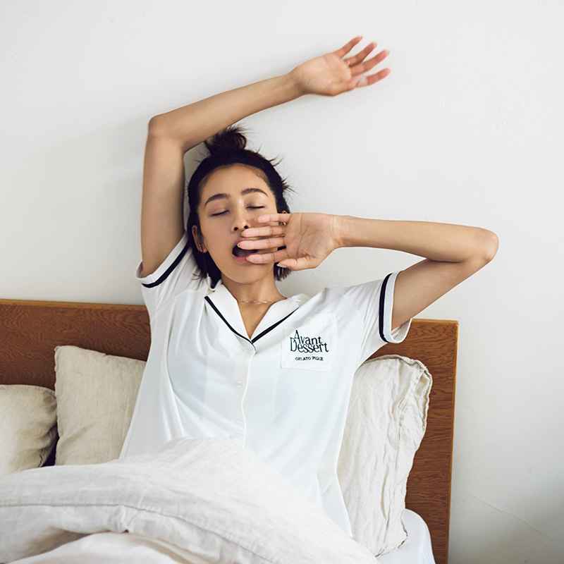 パジャマを着たママがベッドであくびをする写真